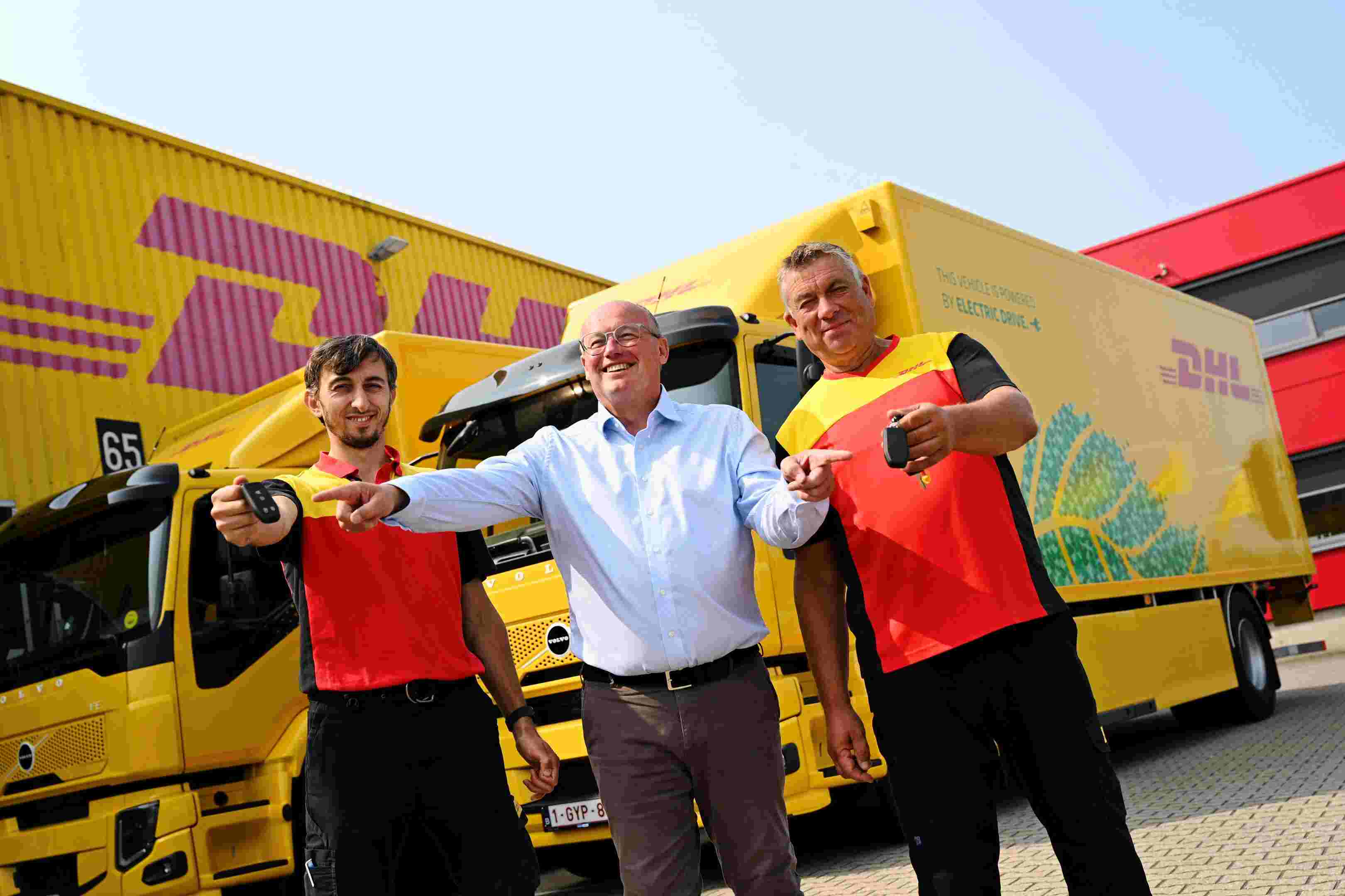 Frank Van Hille handing over keys to drivers electric trucks