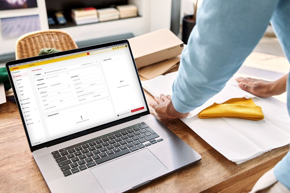 man preparing a shipment in My DHL Portal