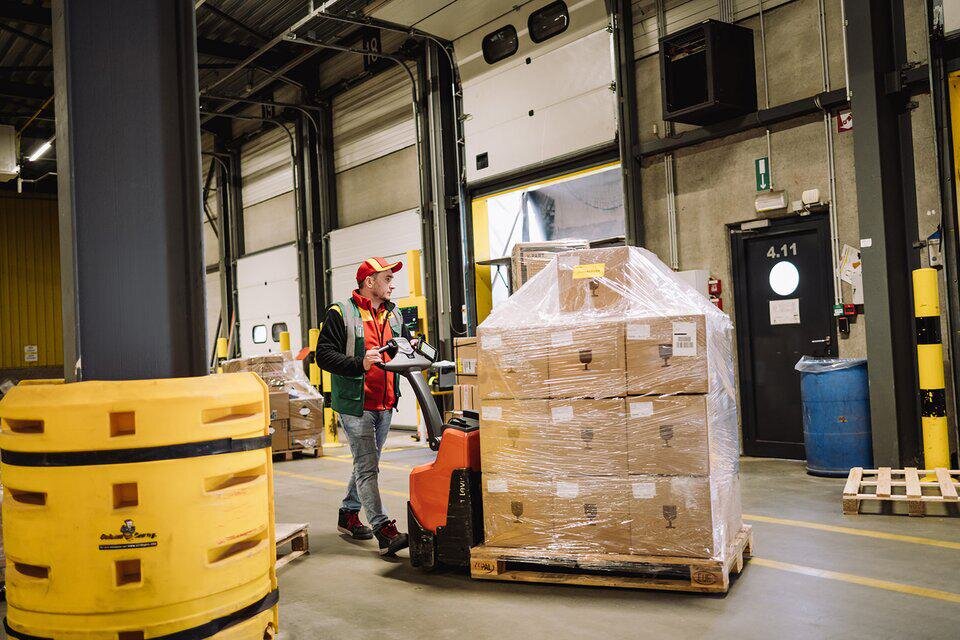 DHL driver loading pallet