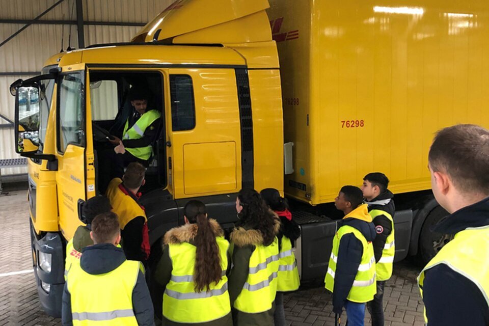 DHL truck driver demonstrating blind spot to children