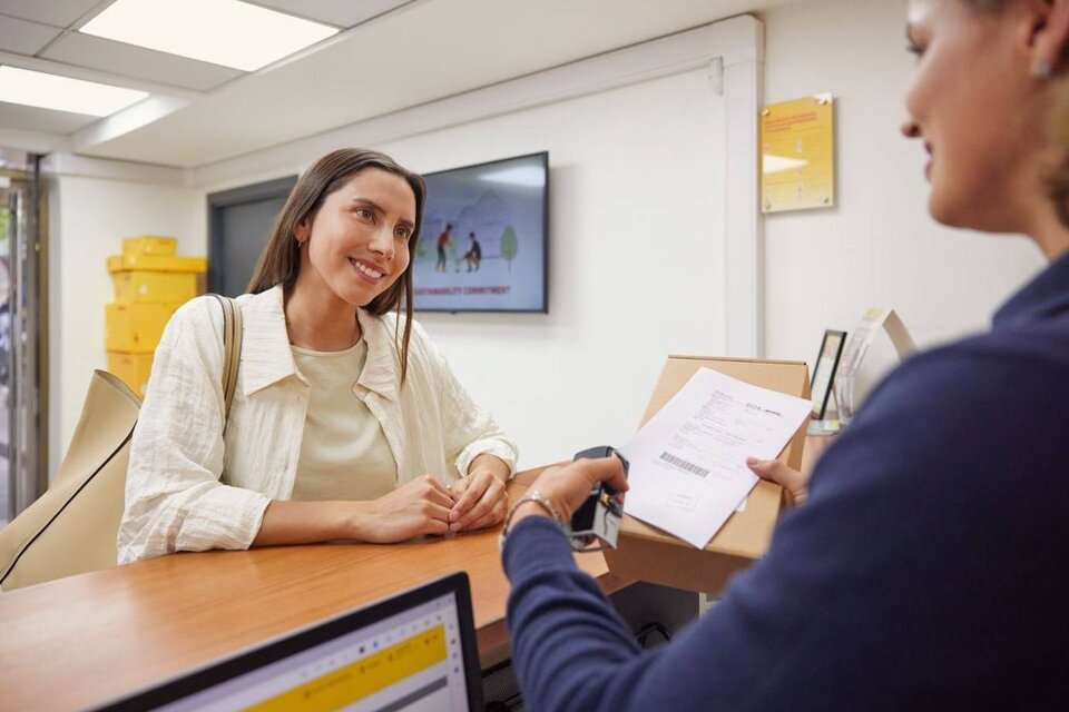 lady collecting a parcel at a DHL ServicePoint