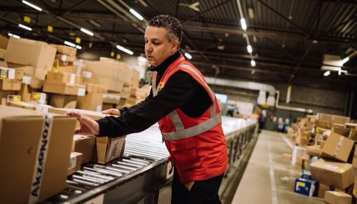 DHL employee sorting parcels