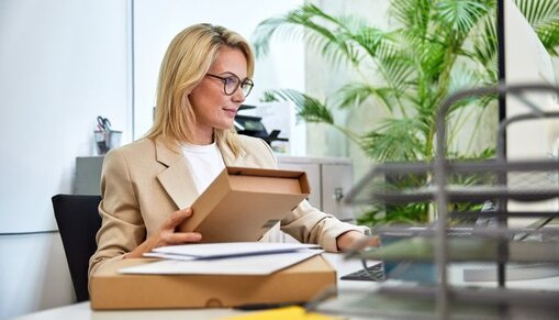 women at desk with parcels