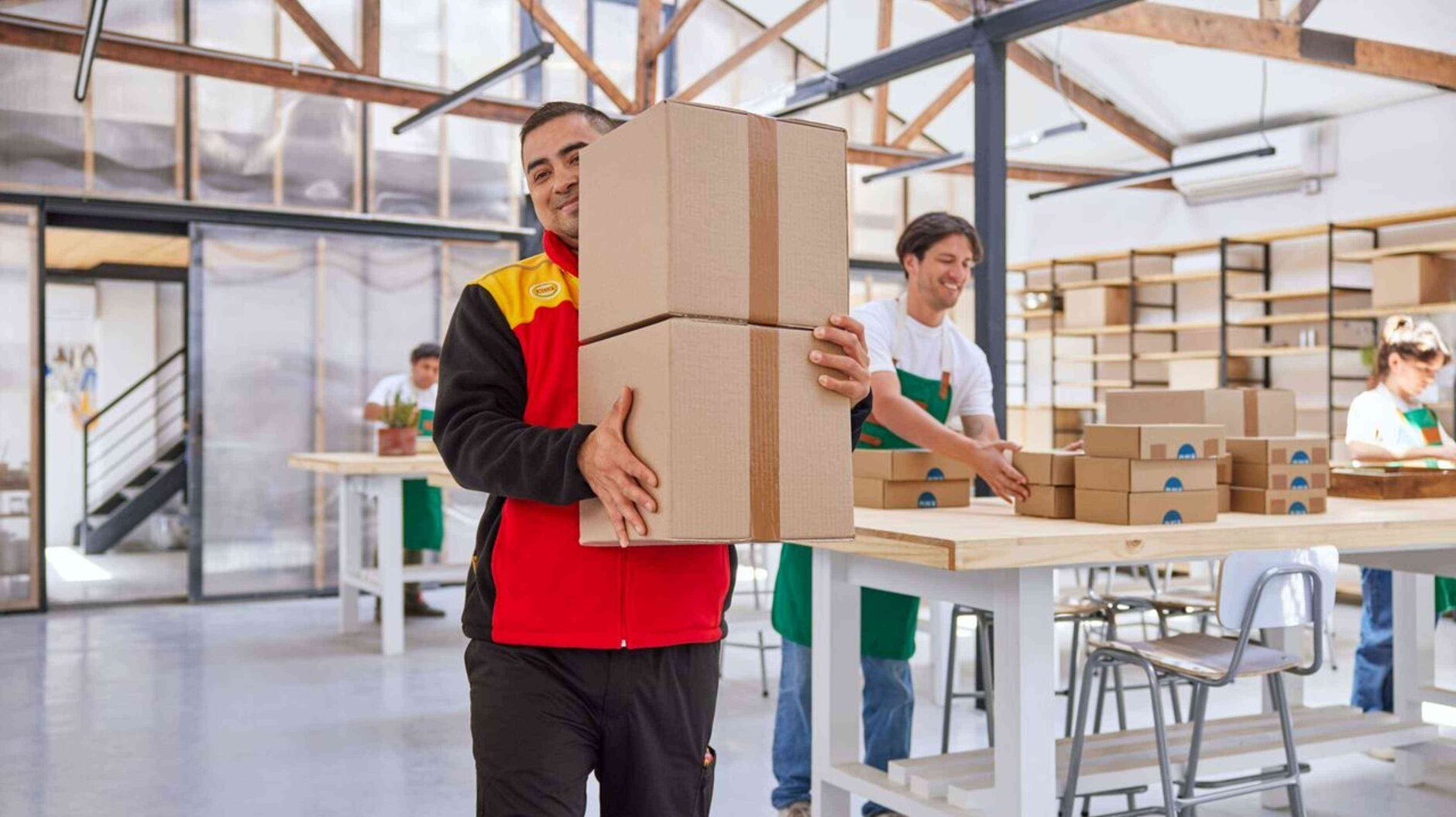 DHL courier picking up goods at warehouse customer