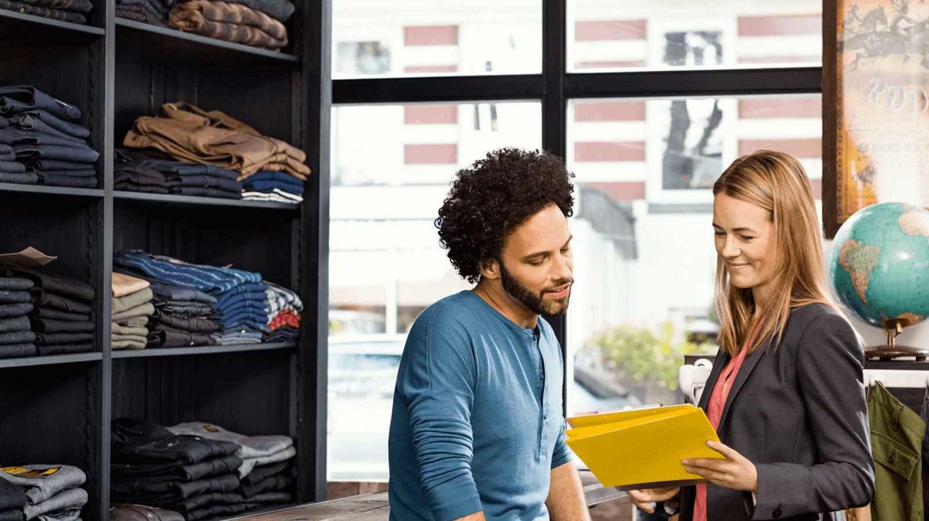 man and woman in clothing shop