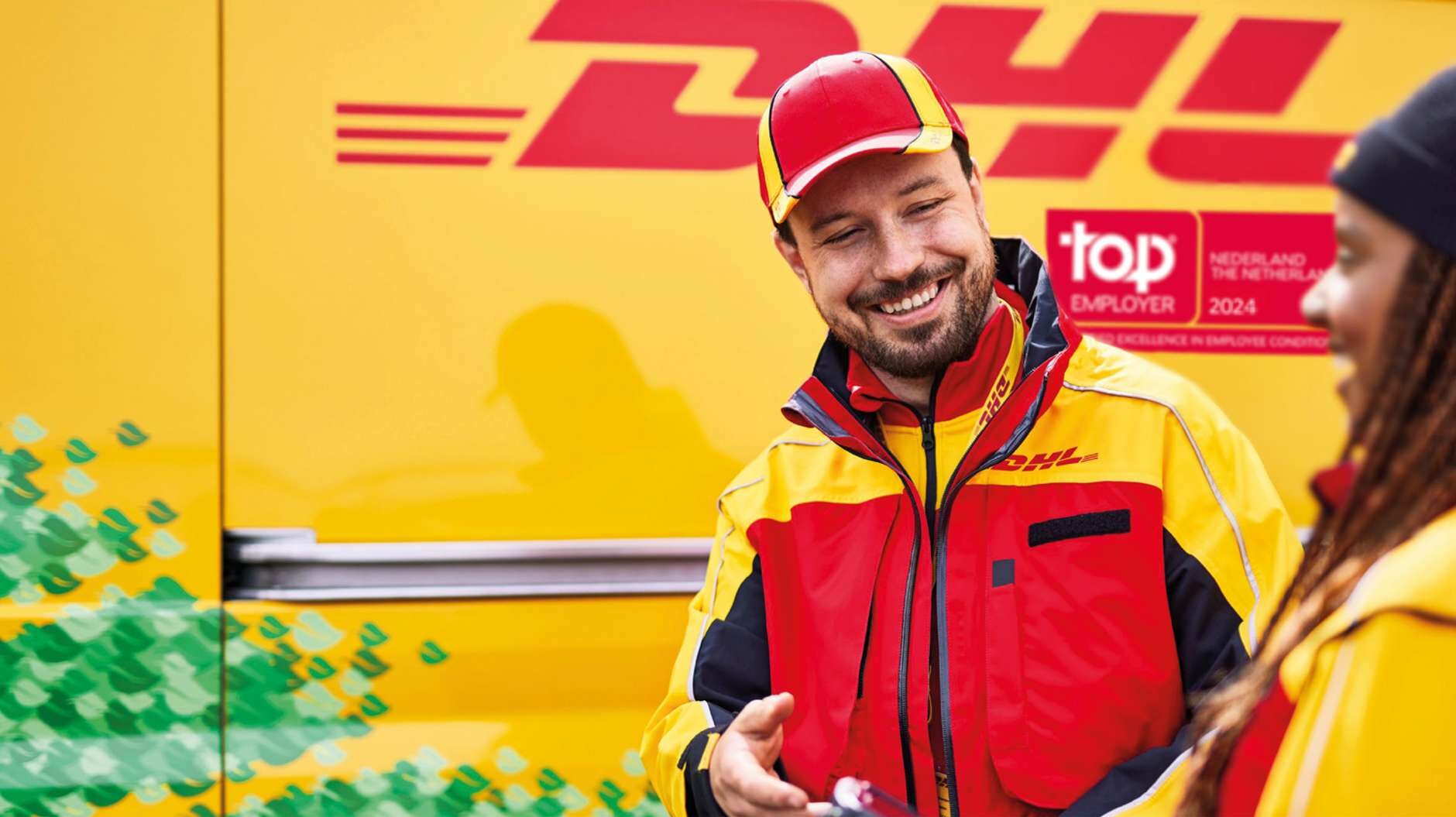 male and female DHL courier next to DHL van