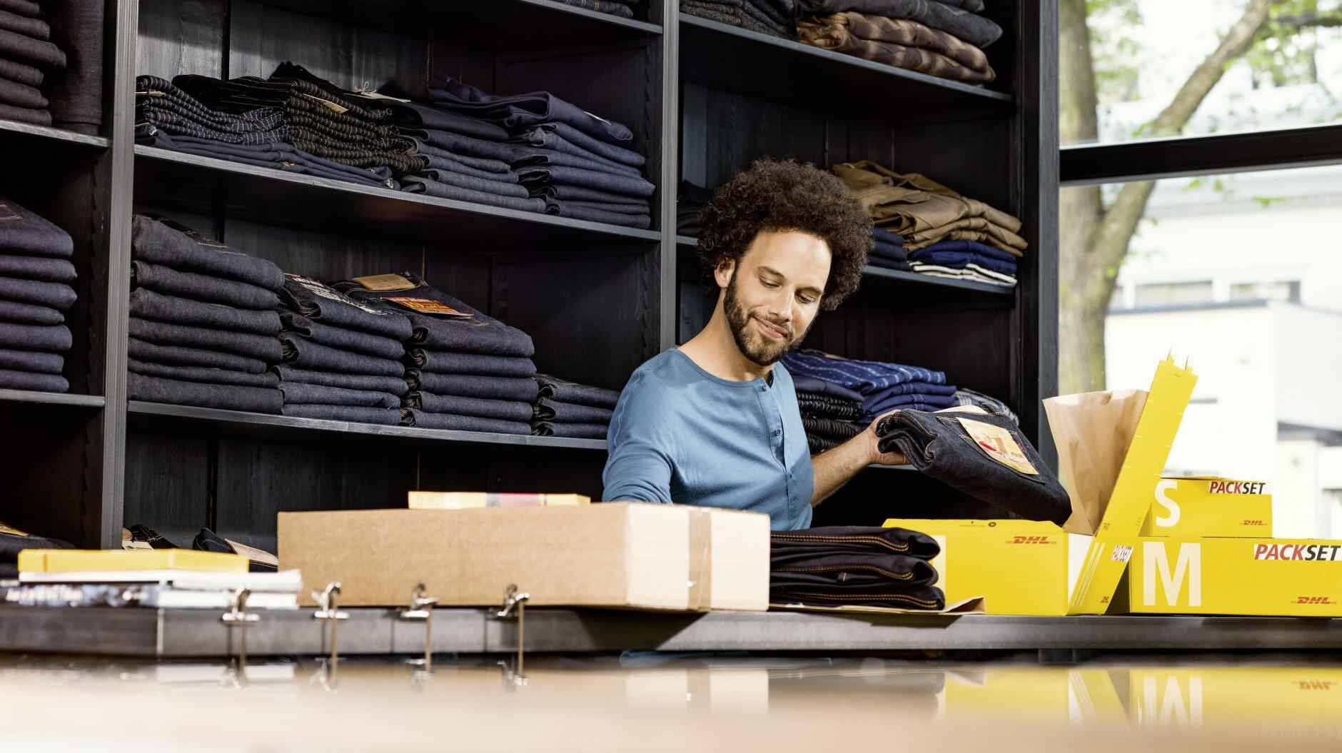 man preparing shipments to be sent with DHL