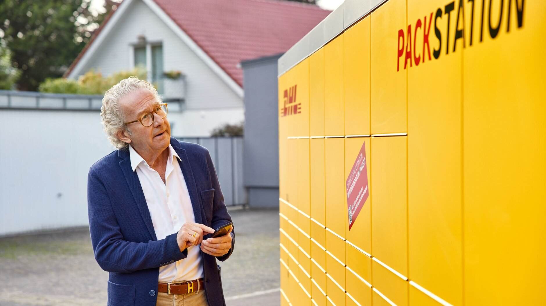 man collecting parcel at packstation in Germany