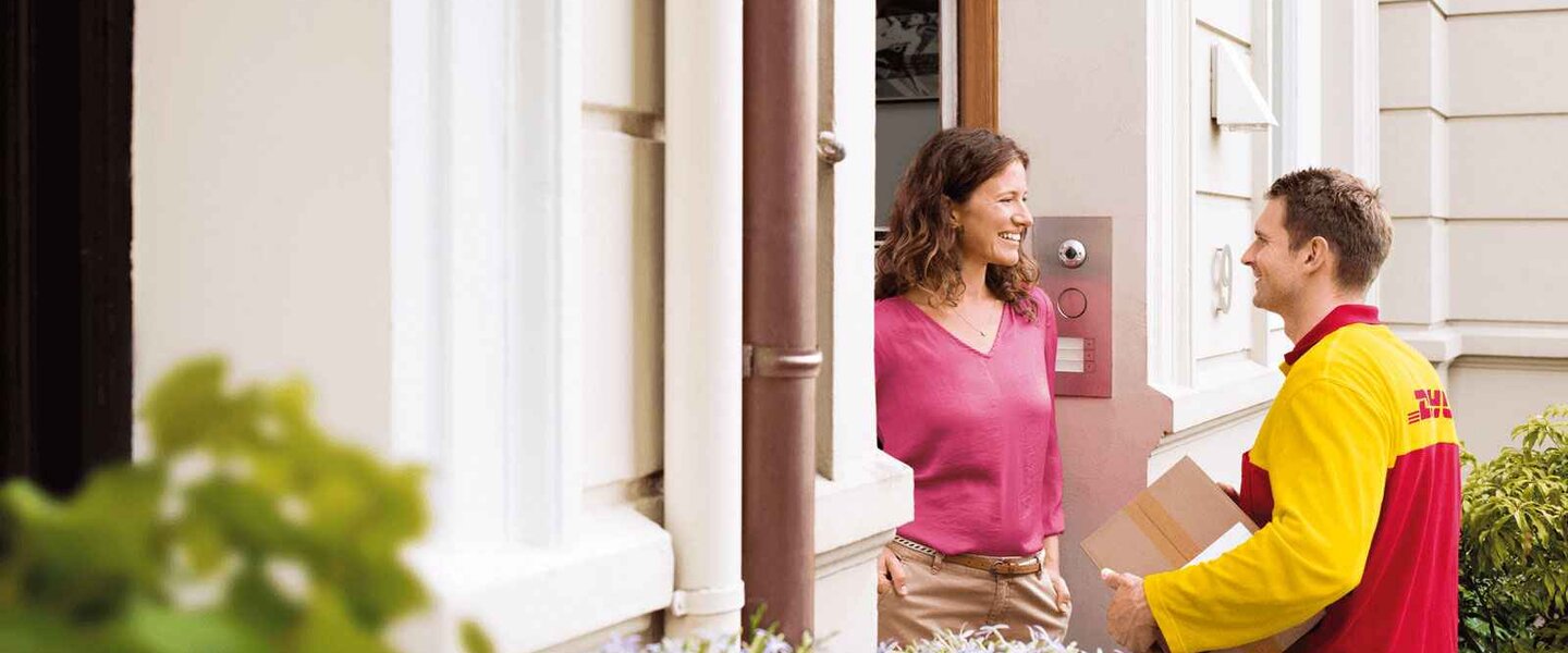 DHL courier delivering parcel at the door