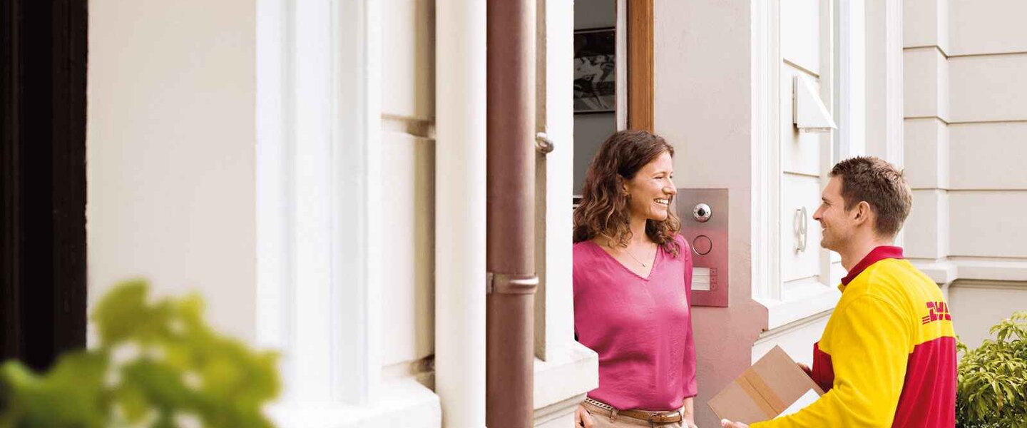 DHL courier delivering parcel at the door