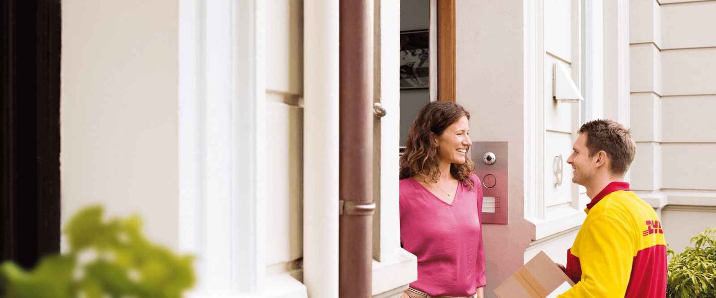 DHL courier delivering parcel at the door