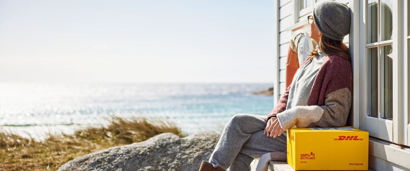 lady with dhl parcel in the sun