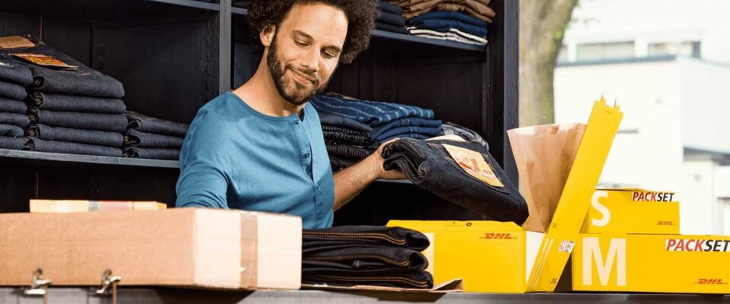 man packing clothes to ship with DHL